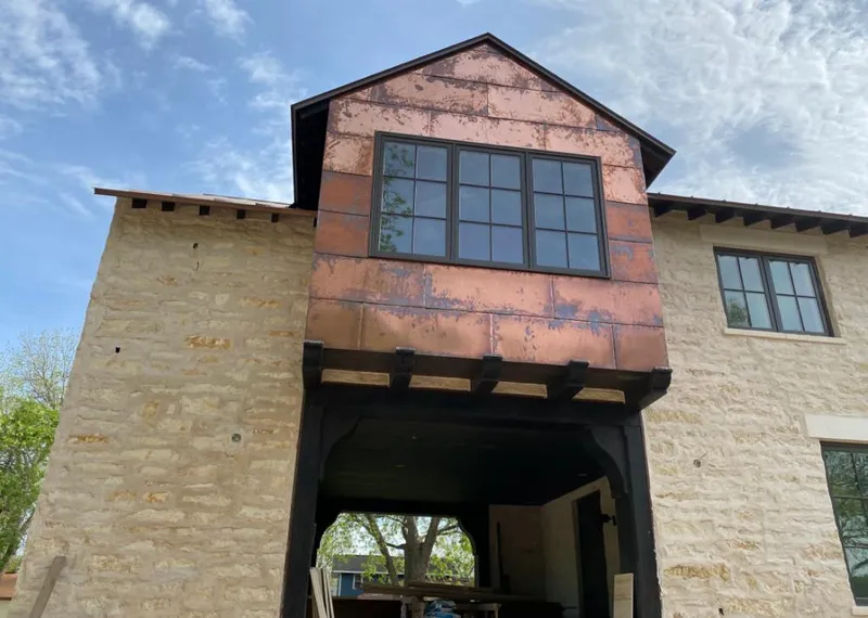 Copper metal panel facade on a stone building for Roof Repair in Corsicana